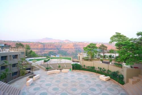 a view of a patio with a view of the mountains at Ikshana Resort and Spa, Khandala in Lonavala