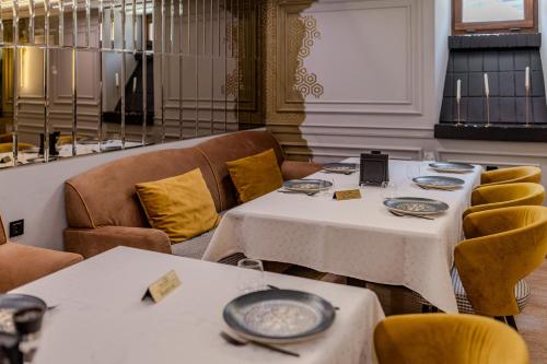 a dining room with two tables and chairs at La Maison de Caroline in Alba Iulia