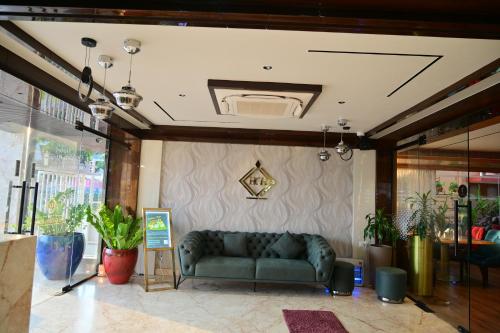 a living room with a couch in a building at Hotel Golden Riviera in Mysore