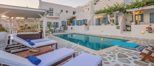 a villa with a swimming pool and a house at Studios Kilindra in Astypalaia Town