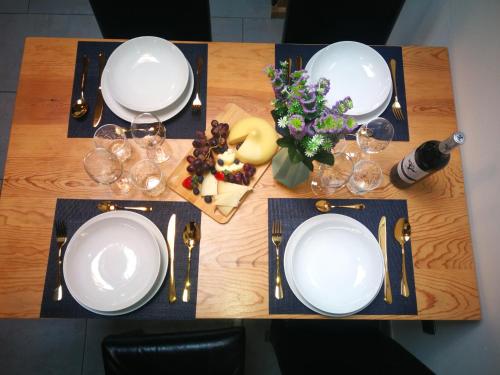 a table with white plates and wine glasses on it at La casa de Sara in Novés de Segre