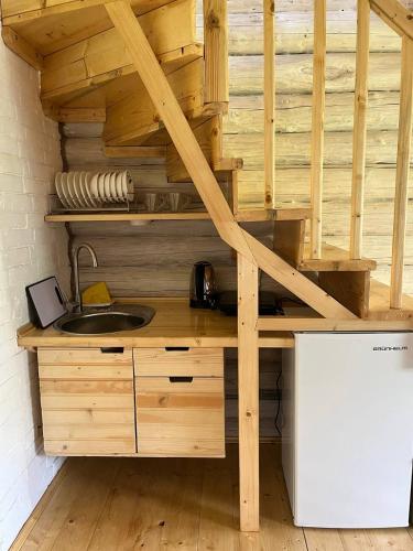 a kitchen with a wooden counter with a sink at ШОВКОВА КОСИЦЯ in Rakhiv
