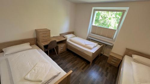a small room with two beds and a window at Apartment in Hannover! contactless check-in in Hannover