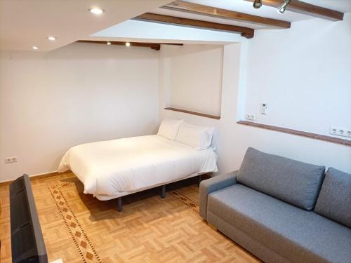 a room with a bed and a couch in it at Villa Matisse Luxury Beach in Torremolinos