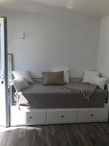 - une chambre blanche avec un grand lit et un miroir dans l'établissement Le cabanon détente, à Bandol