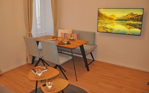 a dining room with a wooden table and chairs at Apartment Austria 206 am Traunsee, Gmunden in Gmunden