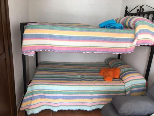 - un lit rayé avec 2 serviettes dans l'établissement Apartamento Mirando al Santuario, à Jaén