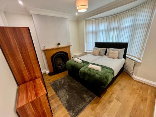 a bedroom with a bed with a fireplace in it at Detached Home with Aircon, Patio, BBQ, Pool Table & Table Tennis in Quinton