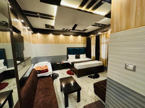 a hotel room with a bed and a couch at Hotel Samiksha Inn in Ayodhya