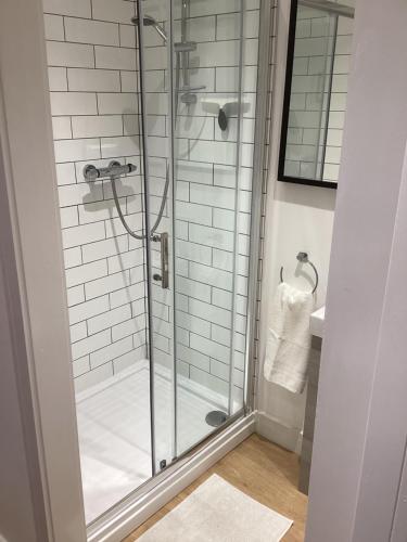 a shower with a glass door in a bathroom at The Tack Shed in Dairsie