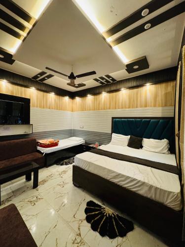 a bedroom with a bed and a couch and a piano at Hotel Samiksha Inn in Ayodhya