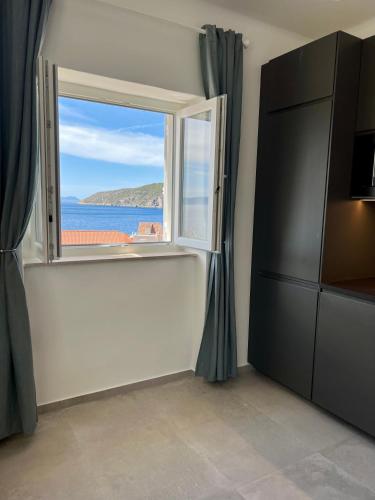 a room with a window with a view of the ocean at Newly Refurbished Komiza Haven in Komiža
