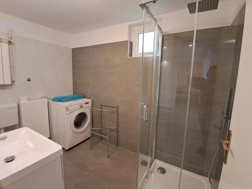 a bathroom with a washing machine and a washer at Apartment Complex Kampic in Poreč