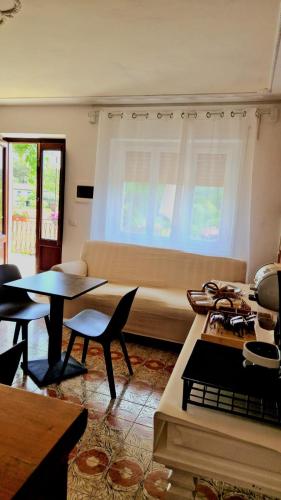a living room with a couch and a table and chairs at Wine House in Capannori