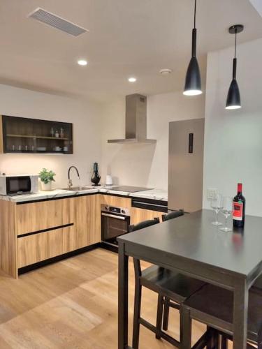 a kitchen with a table with wine glasses on it at Balcón del Malecón in Murcia