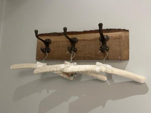 a rack with three white towels on a wall at Picket Post House Bed & Breakfast in Catterall