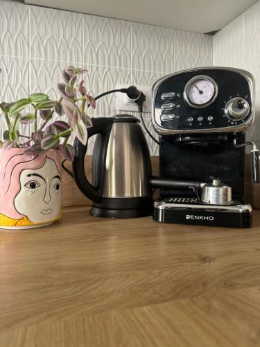 a coffee pot and a toaster on a table at SopraBosco Calcata Art & Design Apartment in Calcata