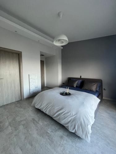 a bedroom with a large bed with a candle on it at Villa Thalia in Kavala