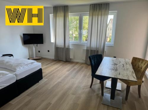a bedroom with a bed and a table with a dining room at Wohnung mit 4 Betten KÖ1 in Hannover