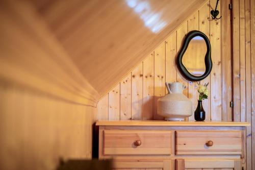 a mirror on top of a dresser with a drawer at Relax house AVUS with Sauna in Slappe dʼIdria