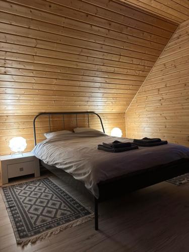 コパリノにあるDomki Skandynawskie Kopalinoの木製の壁のベッドルーム1室