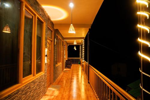 a hallway of a building at night with lights at Odin Hostel Jibhi in Jibhi