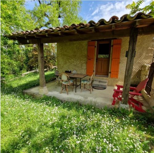 a patio with a table and chairs under a pavilion at Hameau de capuran in Blaziert