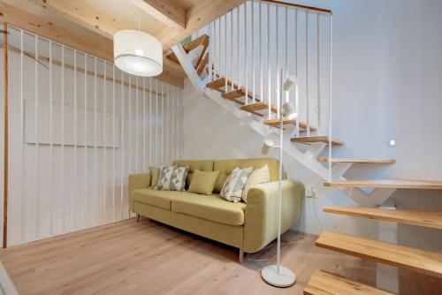een woonkamer met een bank en een trap bij BAY BREEZE Holiday house in Piran in Piran