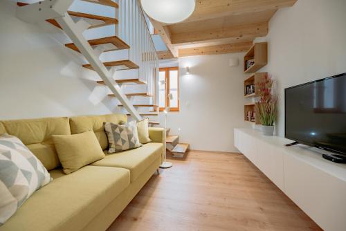 a living room with a couch and a tv at BAY BREEZE Holiday house in Piran in Piran