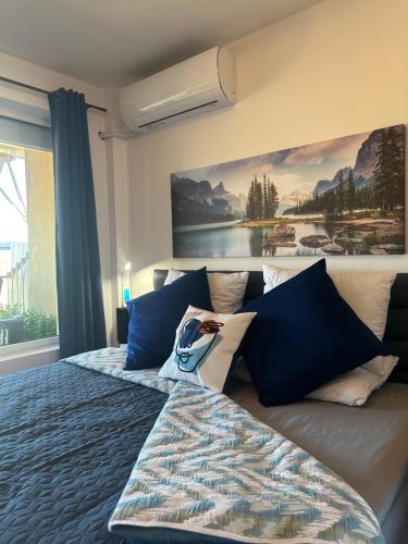 a bedroom with a bed with a painting on the wall at Kolevi Family Seaside Haven! in St. St. Constantine and Helena