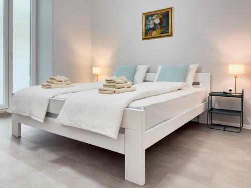 a white bed with towels on it in a bedroom at Apartment Villa Elsa in Portorož