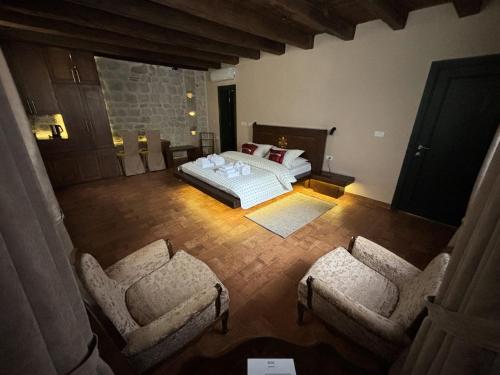 an overhead view of a bedroom with a bed and two chairs at KAŽIN supreme in Kotor