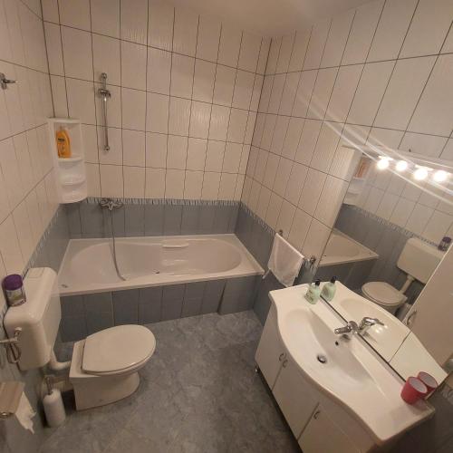 a bathroom with a toilet and a tub and a sink at Regina Hungarorum in Međugorje