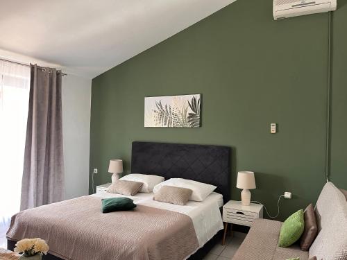 a bedroom with two beds and a green wall at Apartments Villa Mirella 20 m from the sea - free parking in Trogir