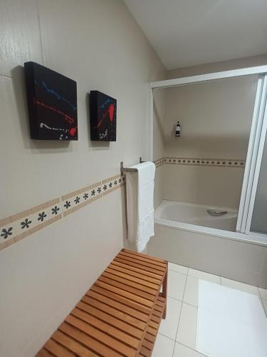 a white bathroom with a tub and a toilet at Camino Santiago Etxea in Jaca