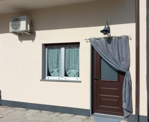 a house with a door and a window at Casa Luce in Marina di Massa