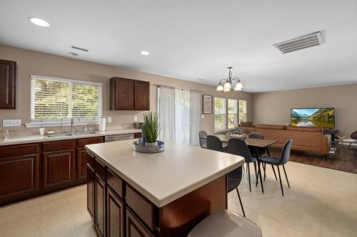a kitchen and living room with a table and chairs at Spacious Home, Large Groups, 5mi from DT Raleigh! in Raleigh