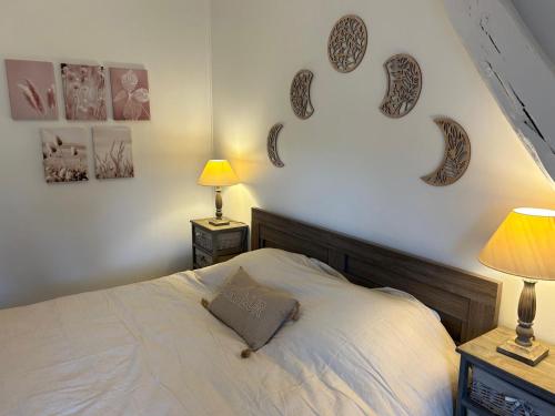 a bedroom with a bed and some pictures on the wall at Maison indépendante 4 chambres proche Chartres et Rambouillet 