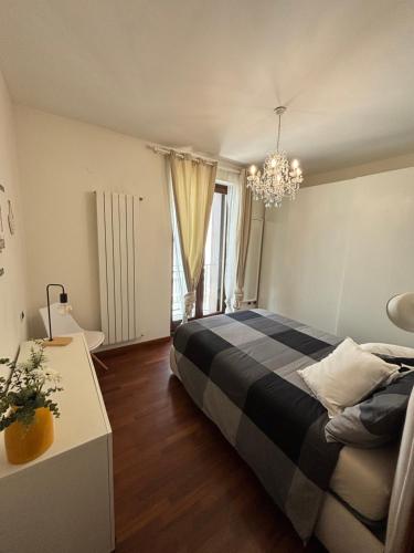 a bedroom with a bed and a chandelier at Michelangelo Apartment Pescara in Pescara