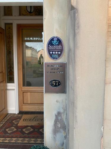 znak na boku budynku przed drzwiami w obiekcie Braidmead House w mieście Irvine