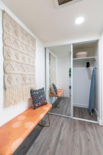 a living room with a bench and a mirror at New DT Alhambra Family Vacation Home with King Bed in Alhambra