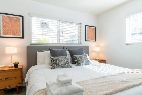 a bedroom with a large white bed with pillows at New DT Alhambra Family Vacation Home with King Bed in Alhambra