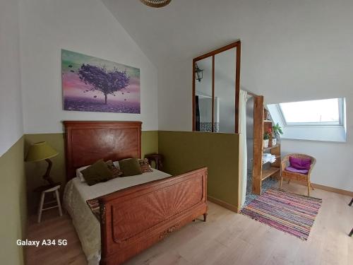 a bedroom with a bed and a large mirror at Les Chaumes Violettes-Chambres & Table d'hôtes à la campagne, Berry in Cluis