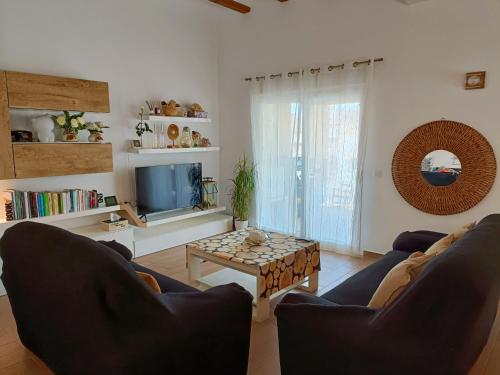 a living room with two couches and a tv at Villa al vent (lujo & relax) in Benitachell