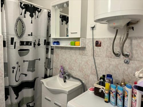 a bathroom with a black and white shower curtain and a sink at APARTMENT ROLEX -near the port Dubrovnik in Dubrovnik