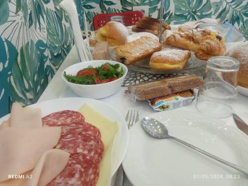 a table with plates of different types of food at Maison De luxe in Pompei