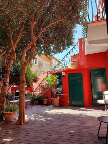 a red building with a green door and a tree at Split Old Town Oasis in Split