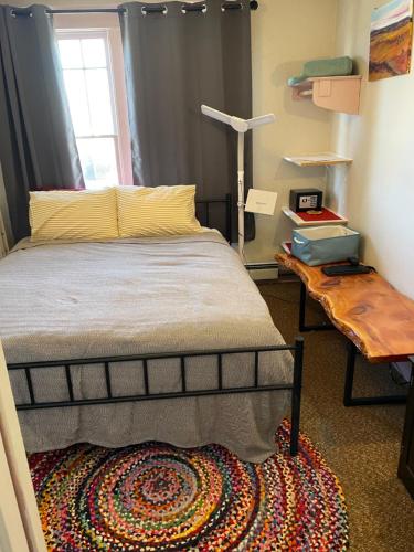 a bedroom with a bed and a table with a lamp at Springer Station in Springer