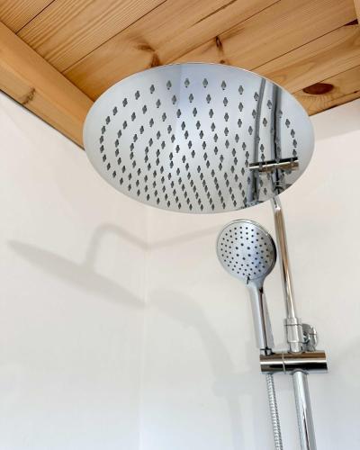 a shower head hanging from a ceiling at Valle D`Água - Casas de campo in Vale de Água