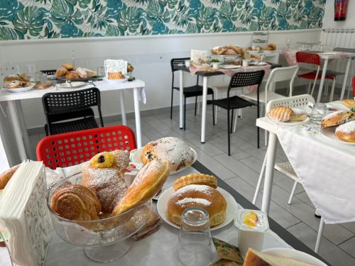 a table with a tray of bread and pastries on it at Maison De luxe in Pompei